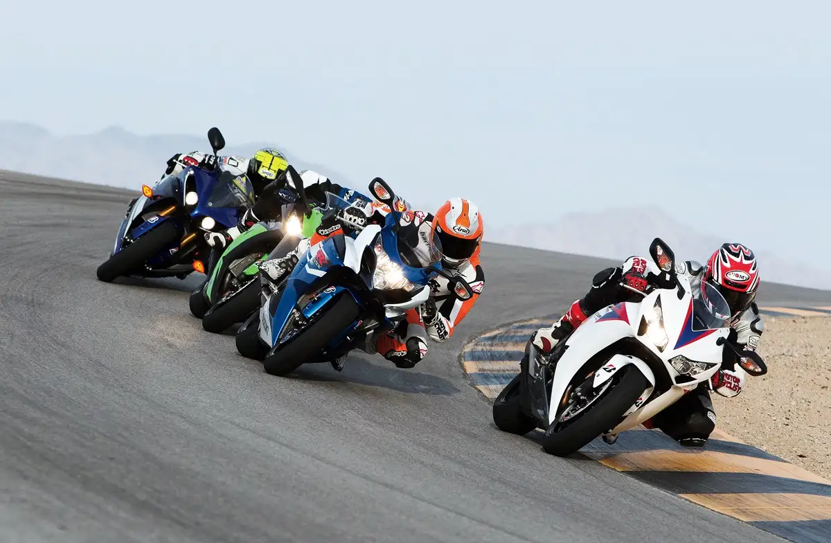 Motorcycle racers leaning into a turn on a race track